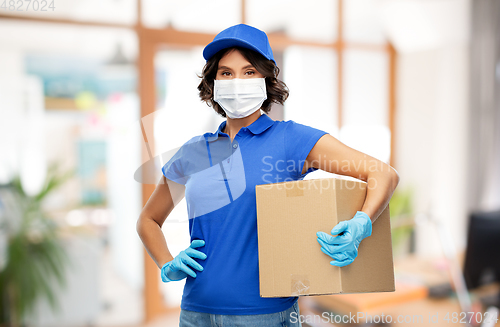 Image of delivery girl in mask holding parcel box at office