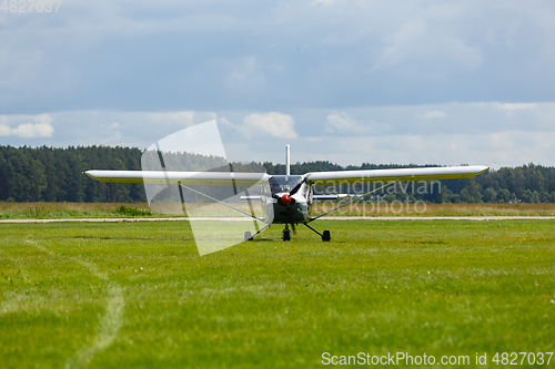 Image of small plane on green field before take-off outdoors