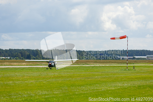 Image of small plane on green field before take-off outdoors