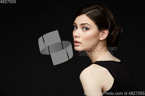 Image of beautiful girl with hairdo on balck background