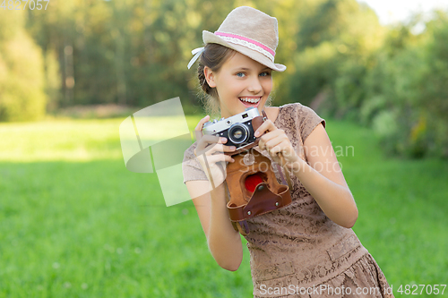 Image of beautiful teen age girl with retro camera