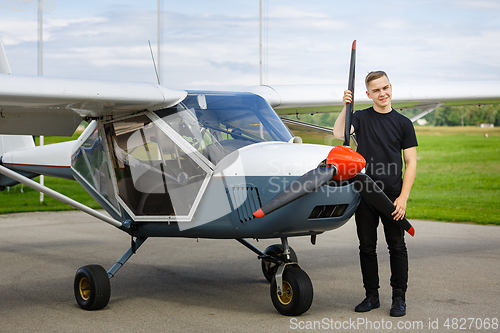 Image of young man in small plane cockpit