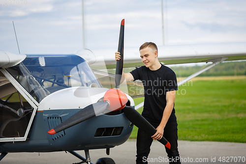 Image of young man in small plane cockpit