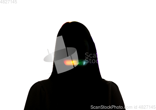 Image of Dramatic portrait of a girl in the dark on white studio background with rainbow colored line