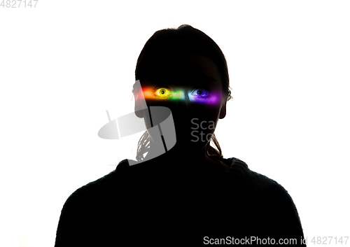Image of Dramatic portrait of a girl in the dark on white studio background with rainbow colored line