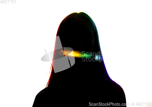 Image of Dramatic portrait of a girl in the dark on white studio background with rainbow colored line