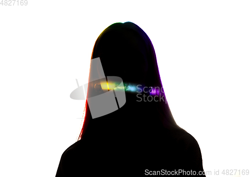 Image of Dramatic portrait of a girl in the dark on white studio background with rainbow colored line