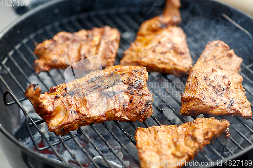 Image of close up of barbecue meat roasting on grill