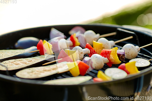 Image of vegetables and mushrooms roasting on brazier grill