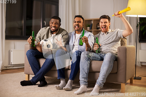 Image of friends or soccer fans with ball and beer at home