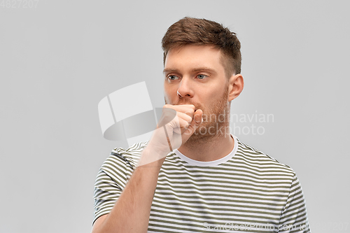 Image of unhealthy young man coughing