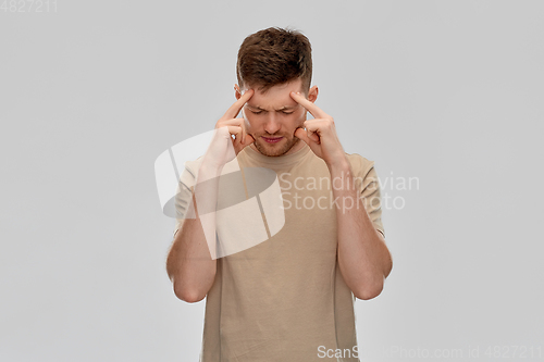 Image of unhappy man suffering from headache