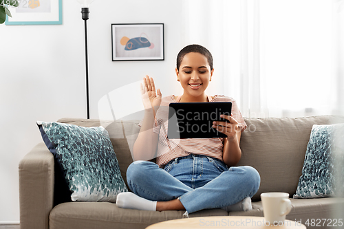 Image of african woman having video call on tablet pc