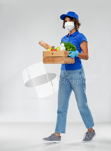 Image of delivery woman in face mask with food in box