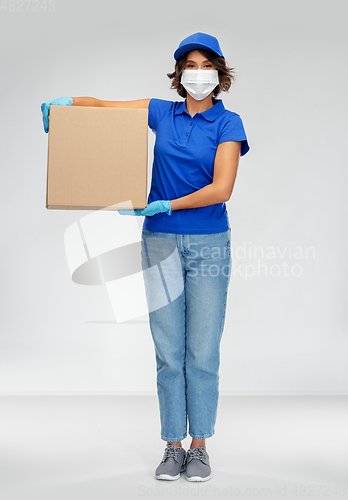 Image of delivery woman in face mask holding parcel box