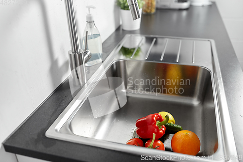 Image of fruits and vegetables in kitchen sink