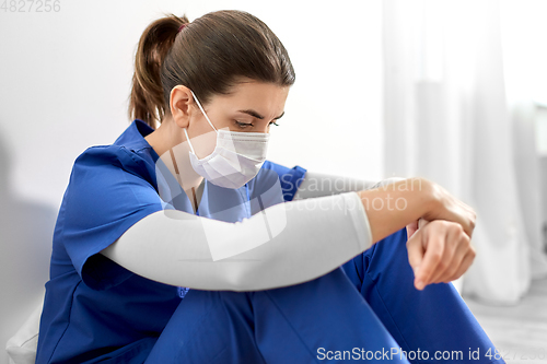 Image of sad doctor or nurse in protective face mask