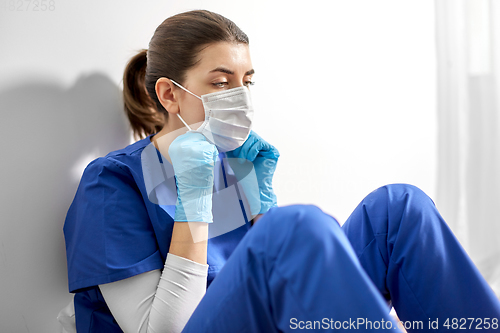 Image of sad doctor or nurse in protective face mask