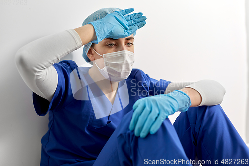 Image of sad doctor or nurse in protective face mask