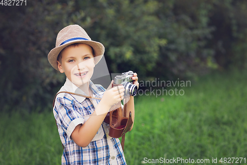 Image of handsome little boy with retro camera