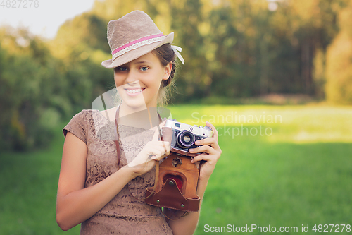 Image of beautiful teen age girl with retro camera