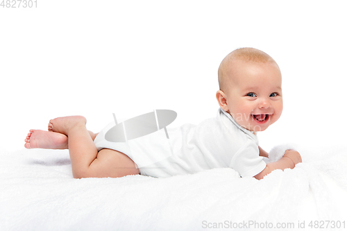 Image of happy beautiful baby girl in white body suit