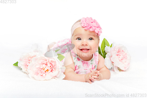 Image of happy beautiful baby girl with flower on head