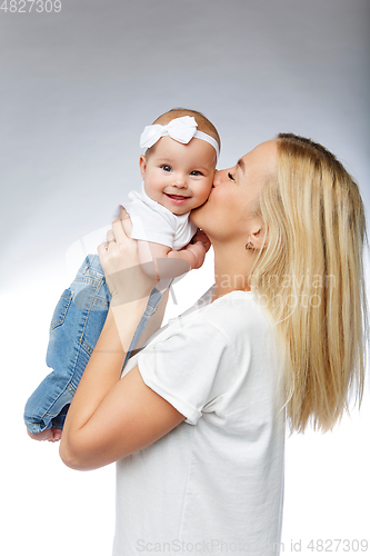 Image of beautiful young mother with toddler baby girl