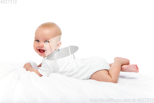 Image of happy beautiful baby girl in white body suit
