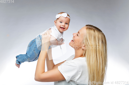 Image of beautiful young mother with toddler baby girl