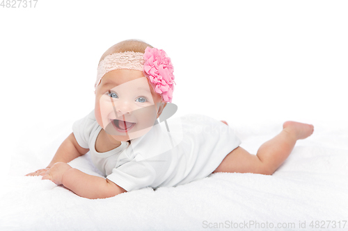 Image of happy beautiful baby girl in white body suit