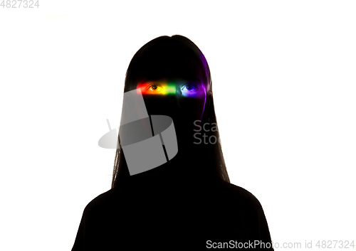 Image of Dramatic portrait of a girl in the dark on white studio background with rainbow colored line