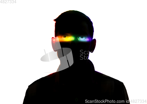 Image of Dramatic portrait of a man in the dark on white studio background with rainbow colored line