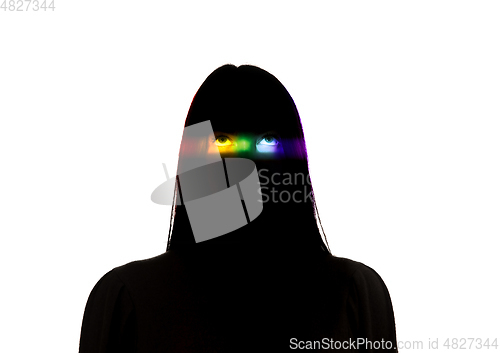 Image of Dramatic portrait of a girl in the dark on white studio background with rainbow colored line