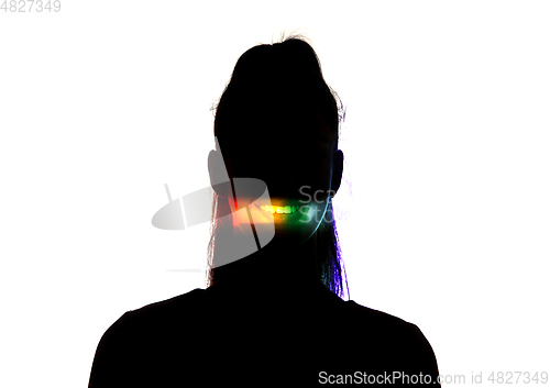 Image of Dramatic portrait of a girl in the dark on white studio background with rainbow colored line