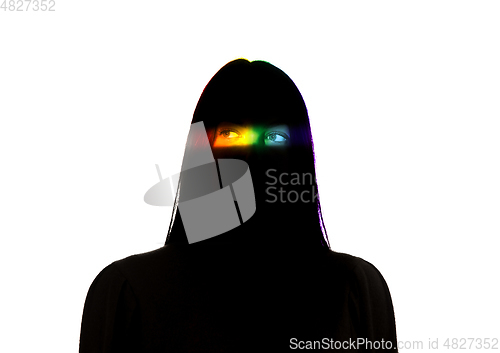 Image of Dramatic portrait of a girl in the dark on white studio background with rainbow colored line