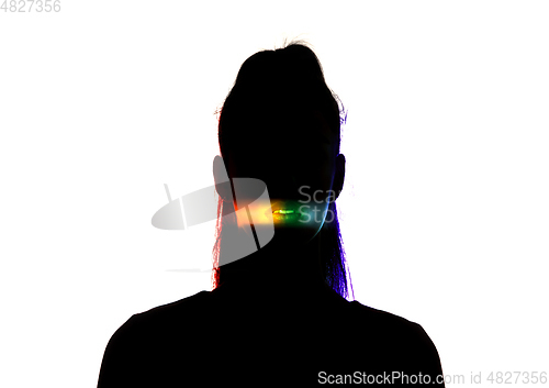 Image of Dramatic portrait of a girl in the dark on white studio background with rainbow colored line