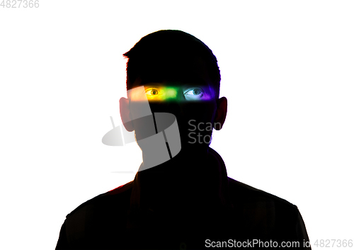 Image of Dramatic portrait of a man in the dark on white studio background with rainbow colored line