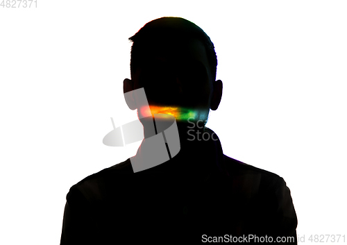 Image of Dramatic portrait of a man in the dark on white studio background with rainbow colored line