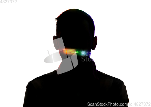 Image of Dramatic portrait of a man in the dark on white studio background with rainbow colored line