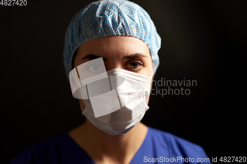 Image of doctor or nurse in medical face mask and hat