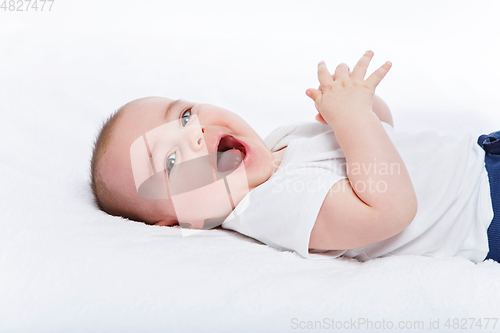 Image of happy beautiful baby boy in white body suit
