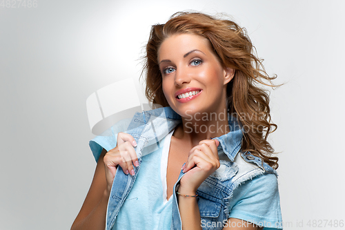 Image of beautiful happy girl in blue jeans jacket