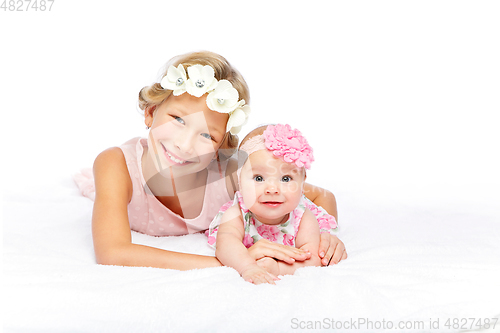 Image of happy beautiful girl with baby baby sister