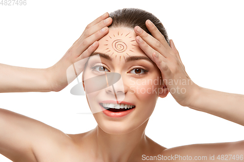 Image of girl with sun drawing on forehead isolated on white