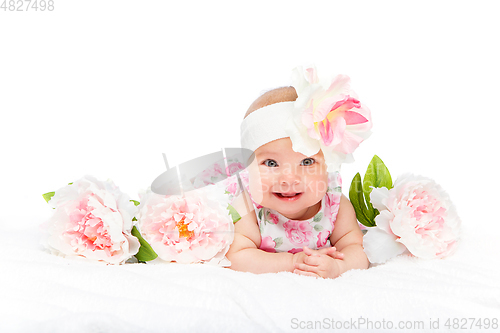 Image of happy beautiful baby girl with flower on head