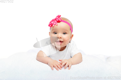 Image of happy beautiful baby girl with pink flower on head