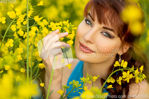 Image of beautiful girl in blue dress with yellow flowers