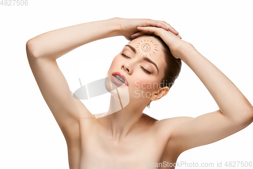 Image of girl with sun drawing on forehead isolated on white