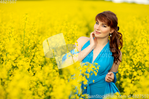 Image of beautiful girl in blue dress with yellow flowers
